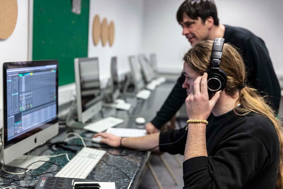 a student and lecturer using imacs in college