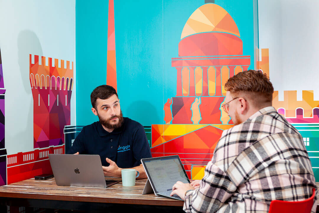 2 men talking at a table