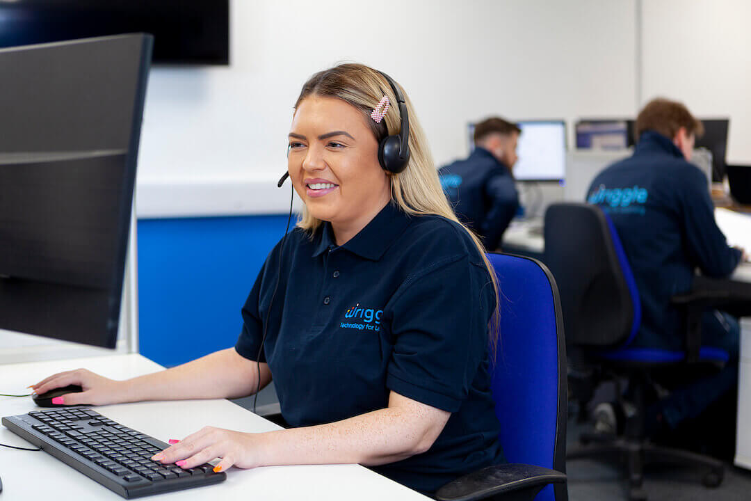 a woman wearing a headset answering the phone