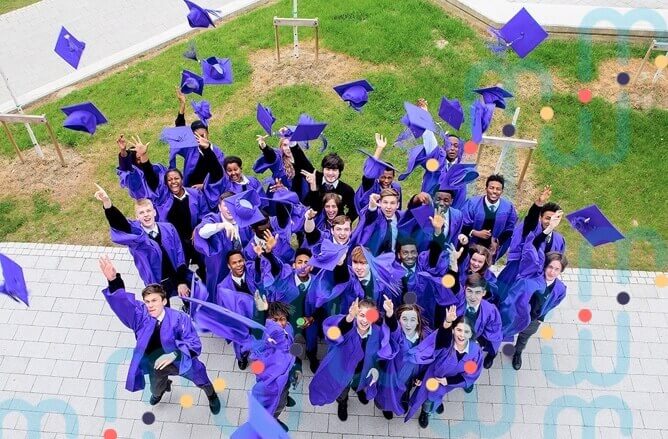 students in purple robes graduating from school