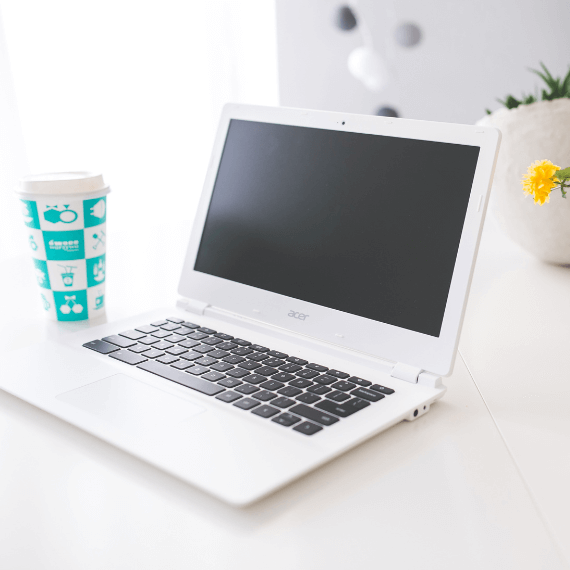 Acer Chromebook sitting on desk with coffee cup