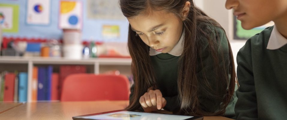 children using iPad in school